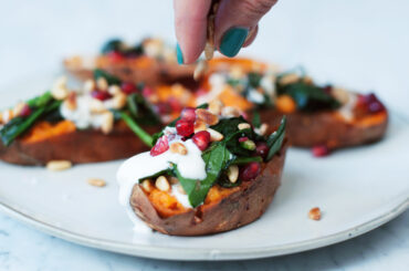 Baked sweet potatoes with spinach and pine nuts