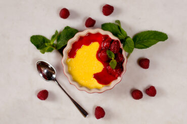 Baked vanilla pudding with hot raspberries