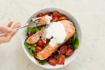 Fried salmon on baby leaf salad