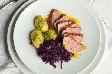 Roast duck with red cabbage and new potatoes