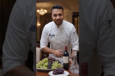 Chef Decorating Table With Juicy Grapes & Wine