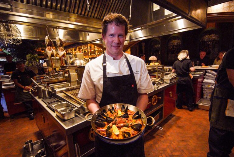Chef Nicholas Dixon with a paella dish at Dalia.